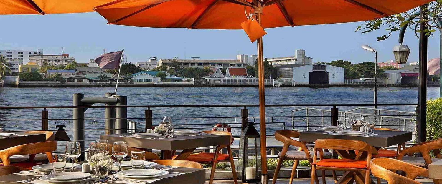 Riverside terrace dining — Riva Surya Bangkok