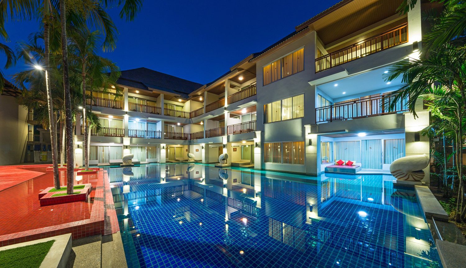 Pool and rooms lit at night — Lanta Sand Resort & Spa