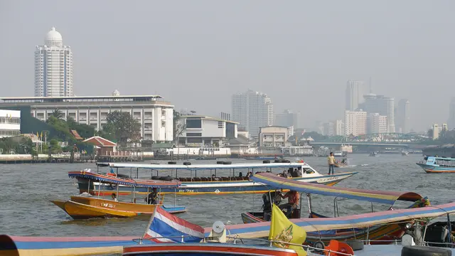 The Chao Phraya river in Bangkok, with express boats and the city skyline