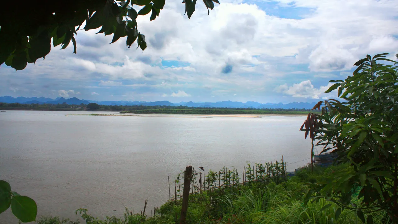 The Mekong and the mountains of Laos seen from the riverbank at Nakhon Phanom